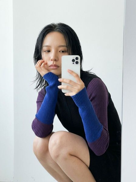 Mirror selfie of crouched pose — AI photo extension by Fraw Official on FRAW